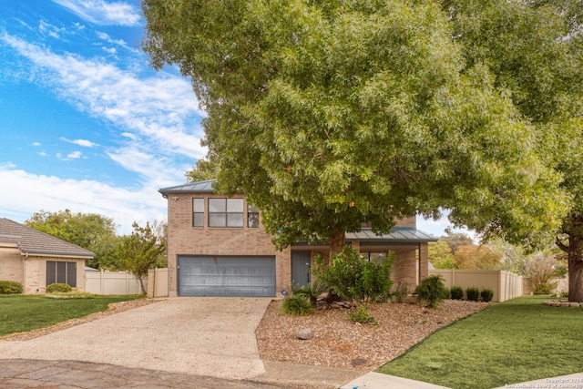 view of front of house with a front yard and a garage