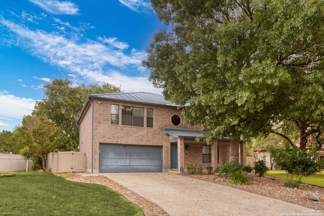 view of front of home featuring a garage and a front lawn