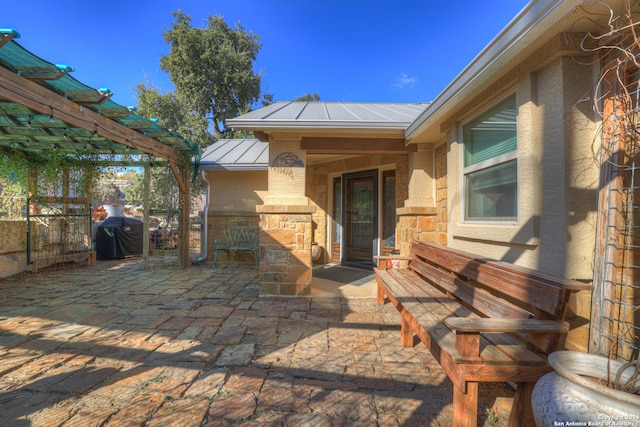 view of patio featuring area for grilling and a pergola