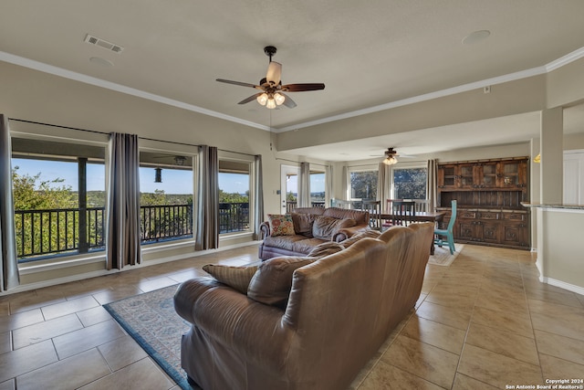 living room featuring crown molding, light tile patterned flooring, and ceiling fan