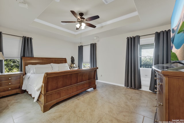 bedroom featuring ceiling fan and a raised ceiling