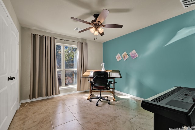 tiled home office featuring ceiling fan