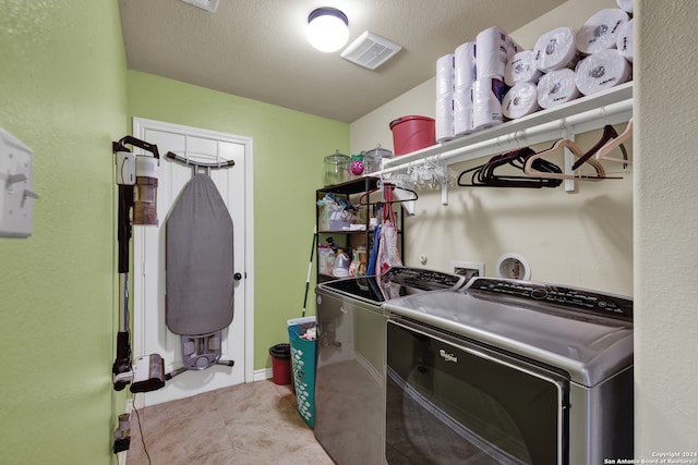 laundry area featuring washer and dryer and a textured ceiling