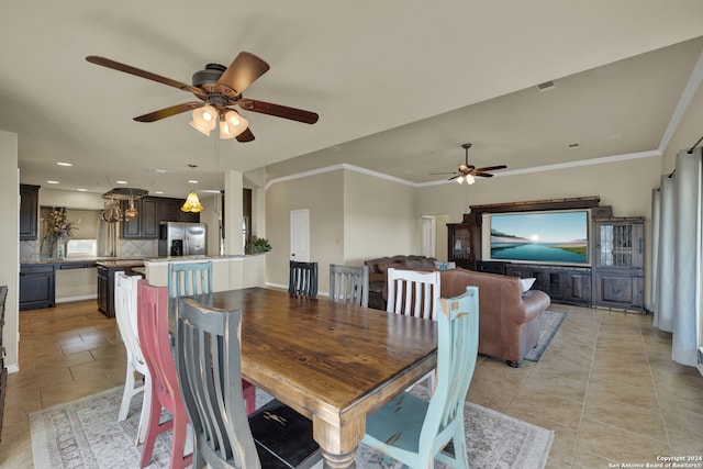 tiled dining area featuring ornamental molding and ceiling fan