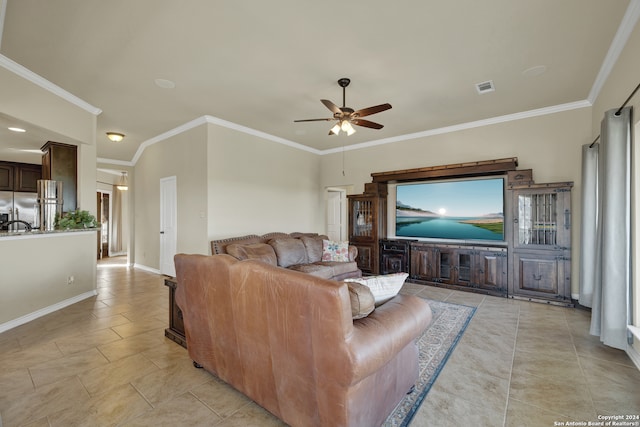 living room featuring ornamental molding, light tile patterned floors, and ceiling fan