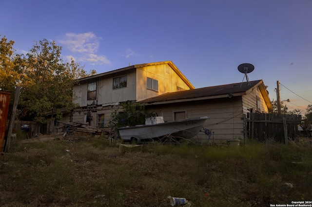 view of back house at dusk