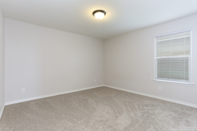 empty room featuring light colored carpet