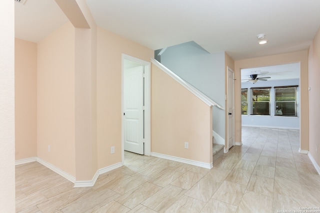 interior space with ceiling fan