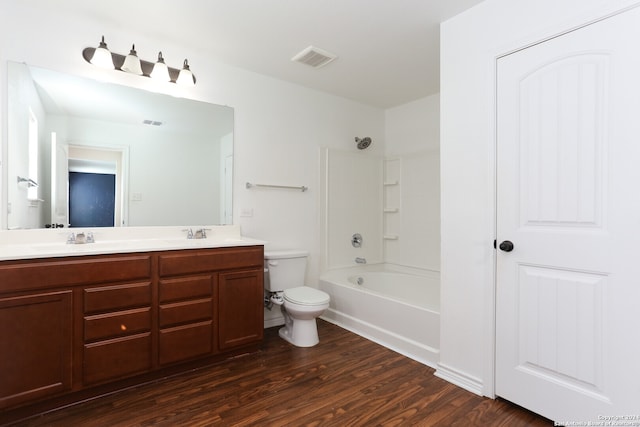 full bathroom with vanity, toilet, hardwood / wood-style flooring, and shower / tub combination