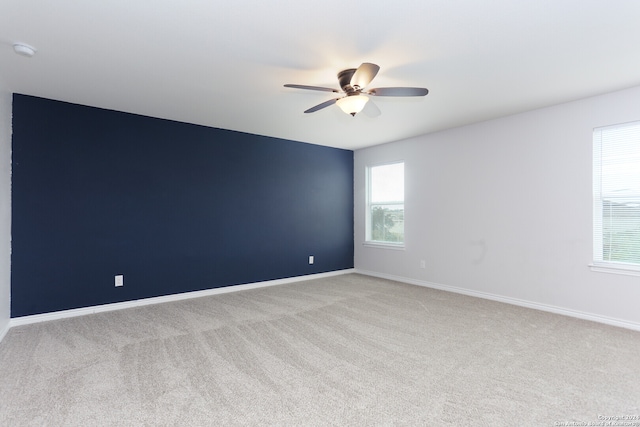 spare room with light carpet and ceiling fan