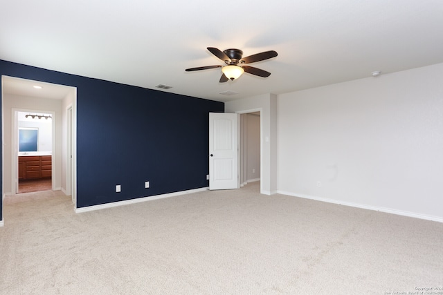 empty room featuring light colored carpet and ceiling fan