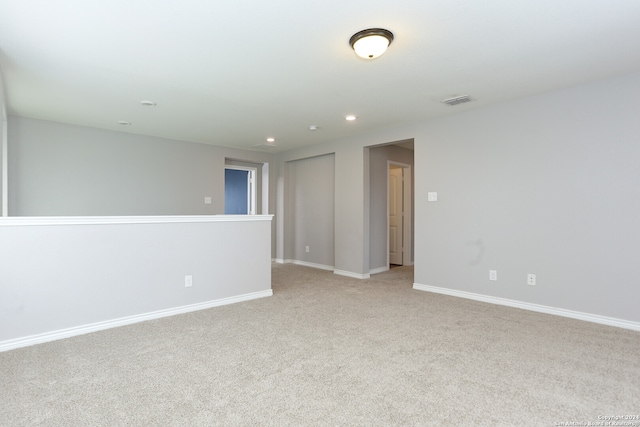 empty room featuring light colored carpet