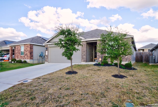 single story home with a front lawn, central AC, and a garage