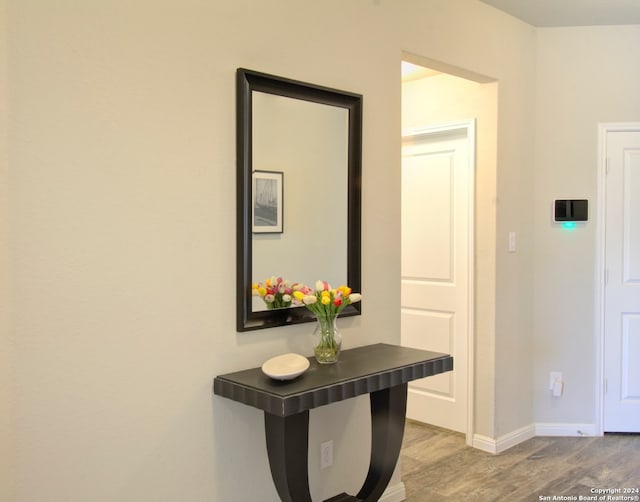 hallway with light hardwood / wood-style flooring