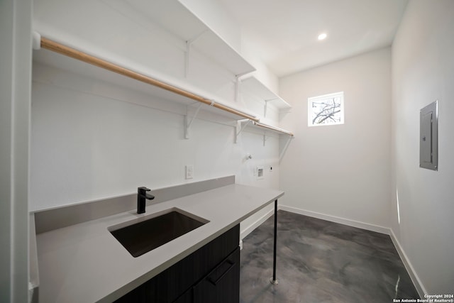 washroom featuring cabinets, hookup for a washing machine, electric panel, and sink