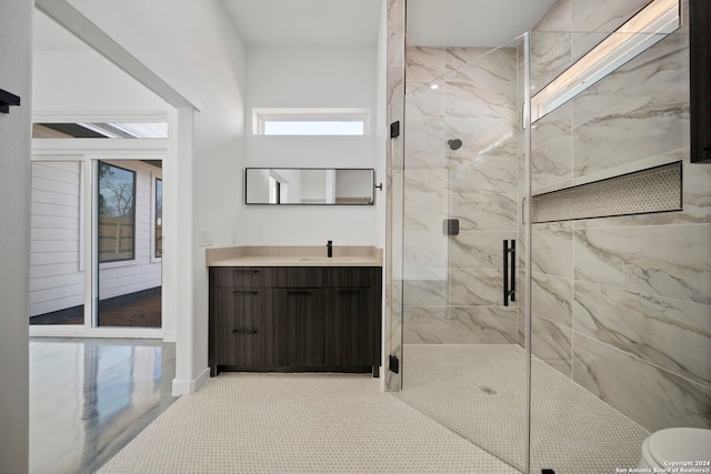 bathroom featuring vanity, walk in shower, toilet, and tile patterned floors