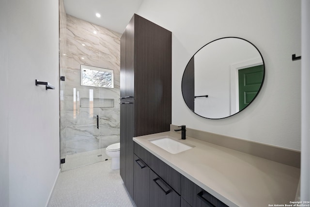 bathroom with vanity, toilet, tile patterned flooring, and an enclosed shower