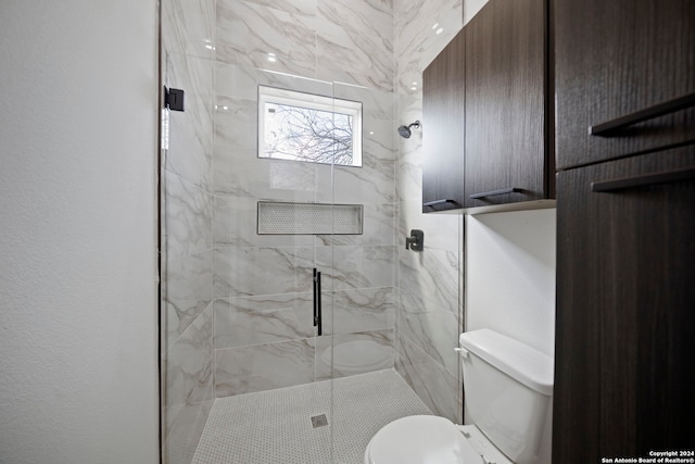 bathroom featuring toilet and walk in shower