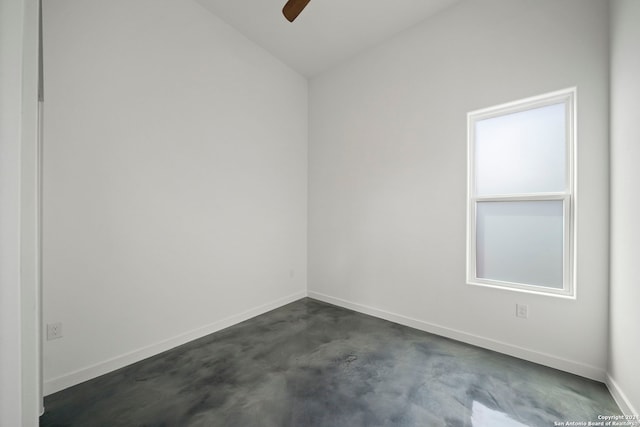 empty room featuring vaulted ceiling and ceiling fan