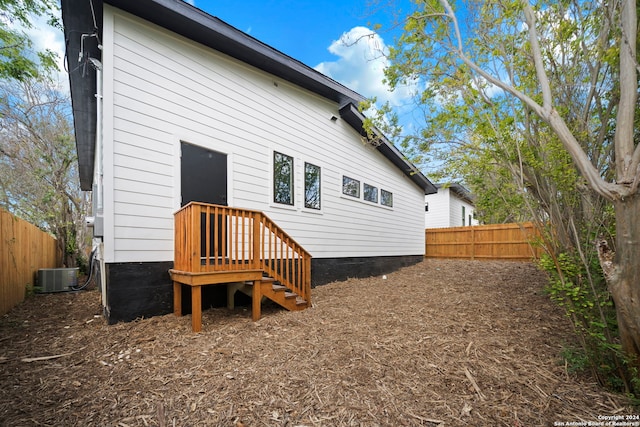 rear view of property with central air condition unit