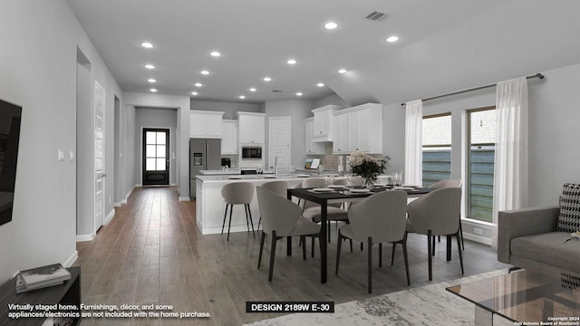 dining space featuring hardwood / wood-style floors, sink, and plenty of natural light