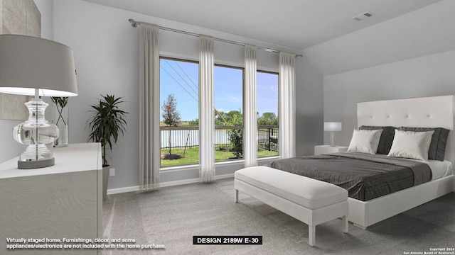 bedroom with carpet flooring and vaulted ceiling