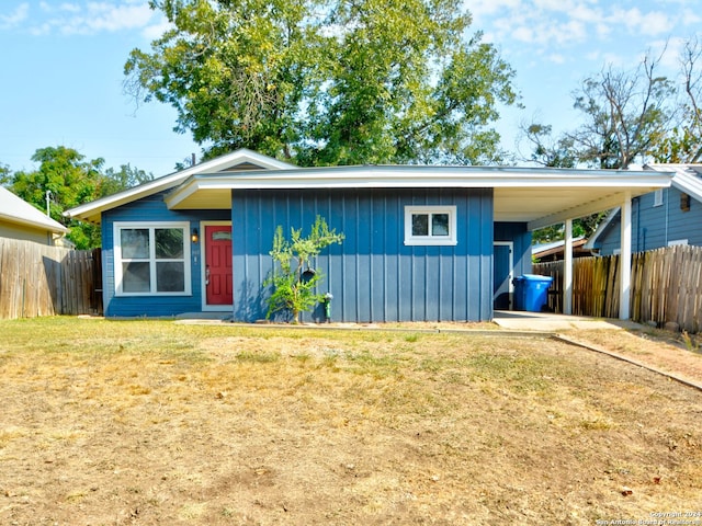 view of front of house with a front lawn and a carport