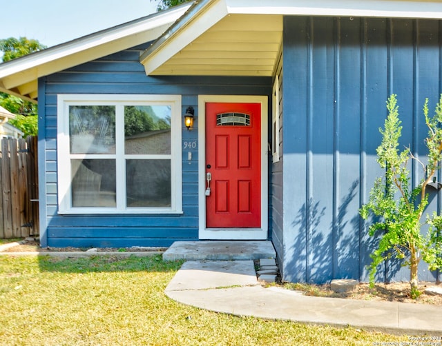 doorway to property featuring a lawn