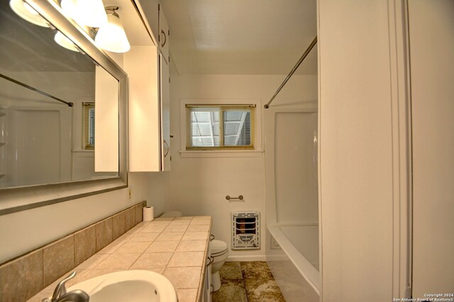 full bathroom featuring toilet, shower / bathing tub combination, vanity, and heating unit