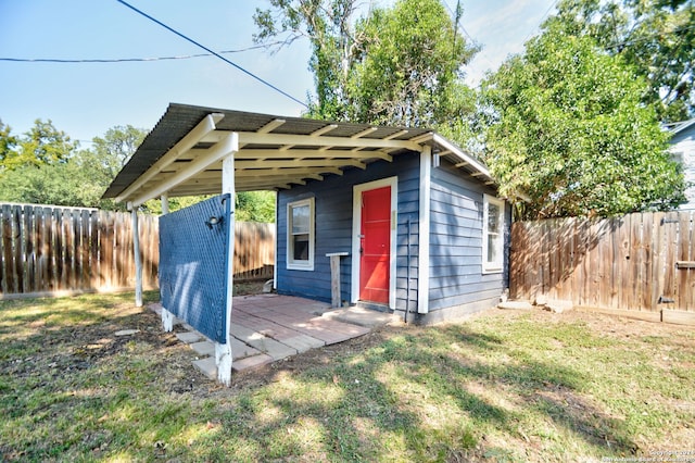 view of outbuilding featuring a yard