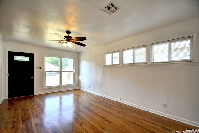 unfurnished room featuring dark hardwood / wood-style floors and ceiling fan