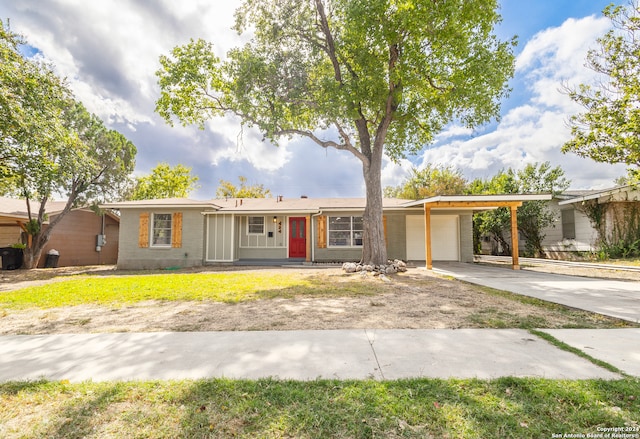 ranch-style house featuring a garage and a carport