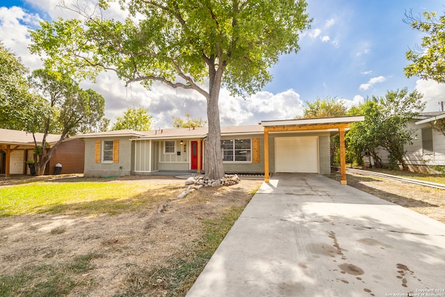 single story home featuring a garage, a front lawn, and a porch