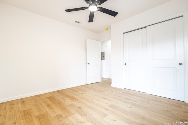 unfurnished bedroom featuring a closet, light hardwood / wood-style floors, and ceiling fan