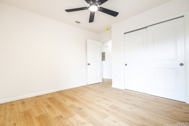 unfurnished bedroom featuring a closet, light wood-type flooring, and ceiling fan