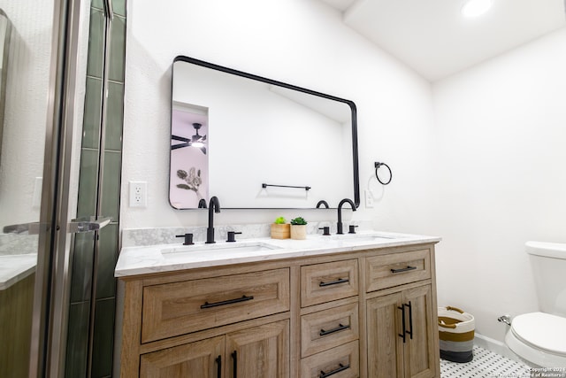 bathroom with toilet, walk in shower, vanity, and tile patterned floors