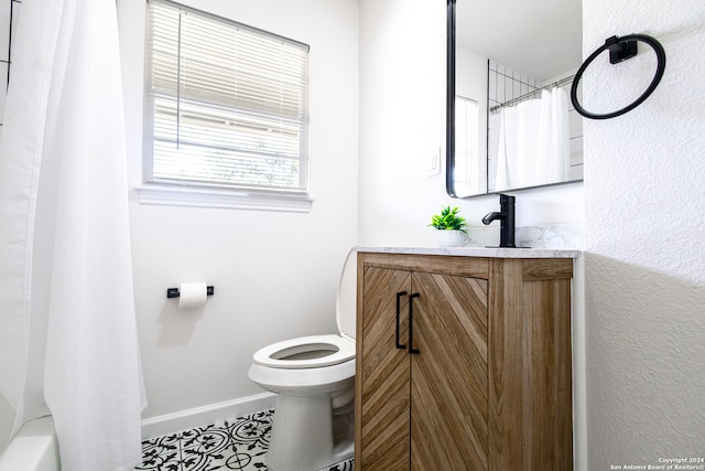 full bathroom with toilet, shower / tub combo with curtain, vanity, and tile patterned flooring