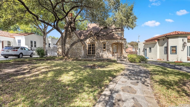 mediterranean / spanish home featuring a front yard