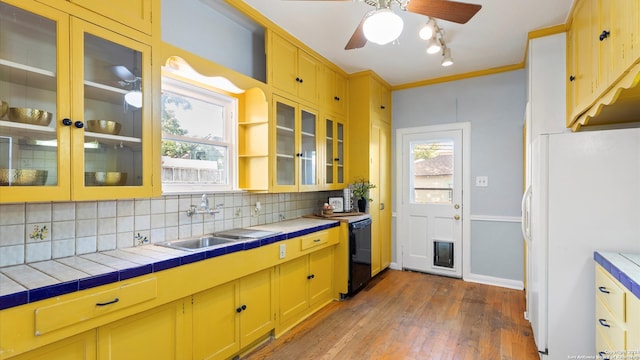 kitchen with white fridge, tile countertops, a wealth of natural light, and sink