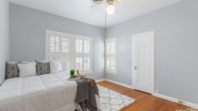 bedroom with light hardwood / wood-style floors and ceiling fan