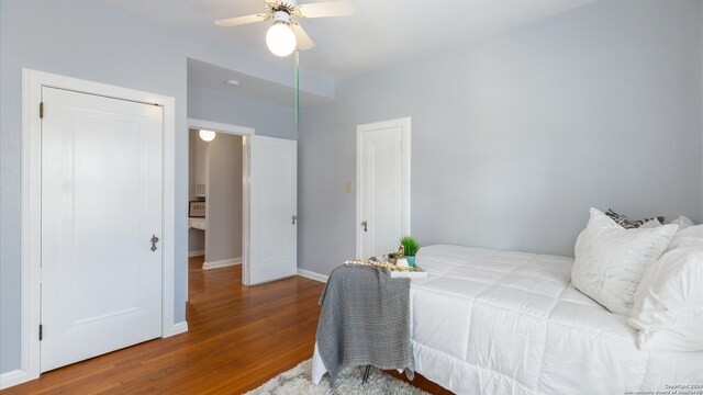 bedroom with hardwood / wood-style floors and ceiling fan