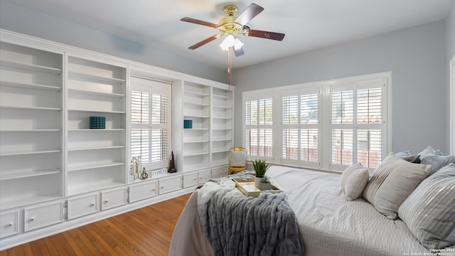 bedroom with ceiling fan, hardwood / wood-style flooring, and multiple windows