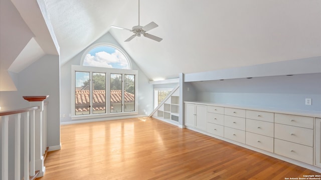 additional living space featuring light hardwood / wood-style floors, lofted ceiling, and ceiling fan