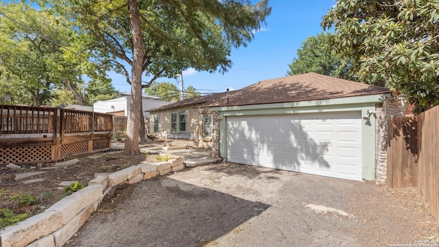 view of front facade with a wooden deck and a garage