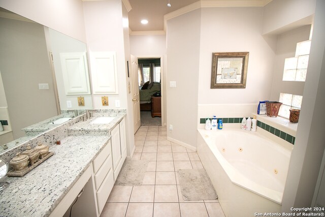 bathroom featuring vanity, a healthy amount of sunlight, crown molding, and tiled bath