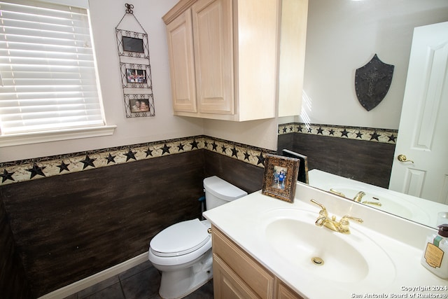 bathroom featuring tile patterned floors, vanity, and toilet