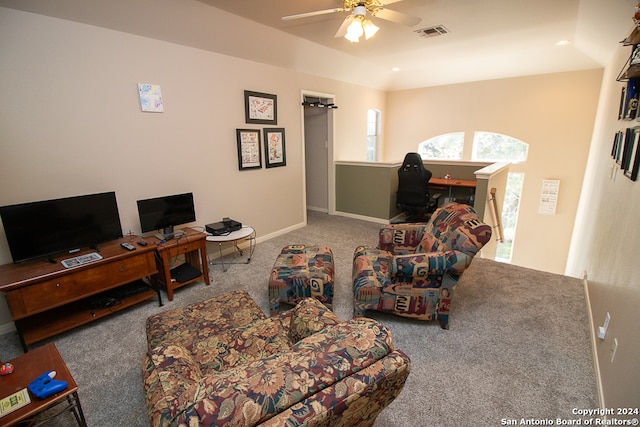 carpeted living room with ceiling fan