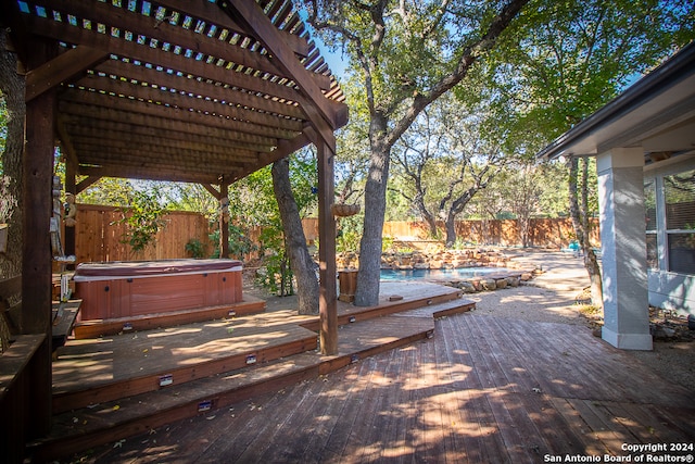 wooden terrace featuring a swimming pool with hot tub and a pergola