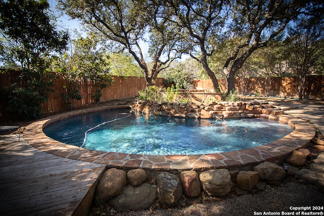 view of swimming pool with a deck