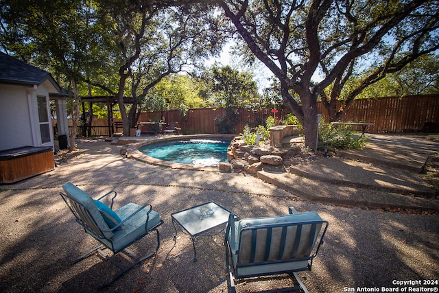 view of pool with a patio and a hot tub